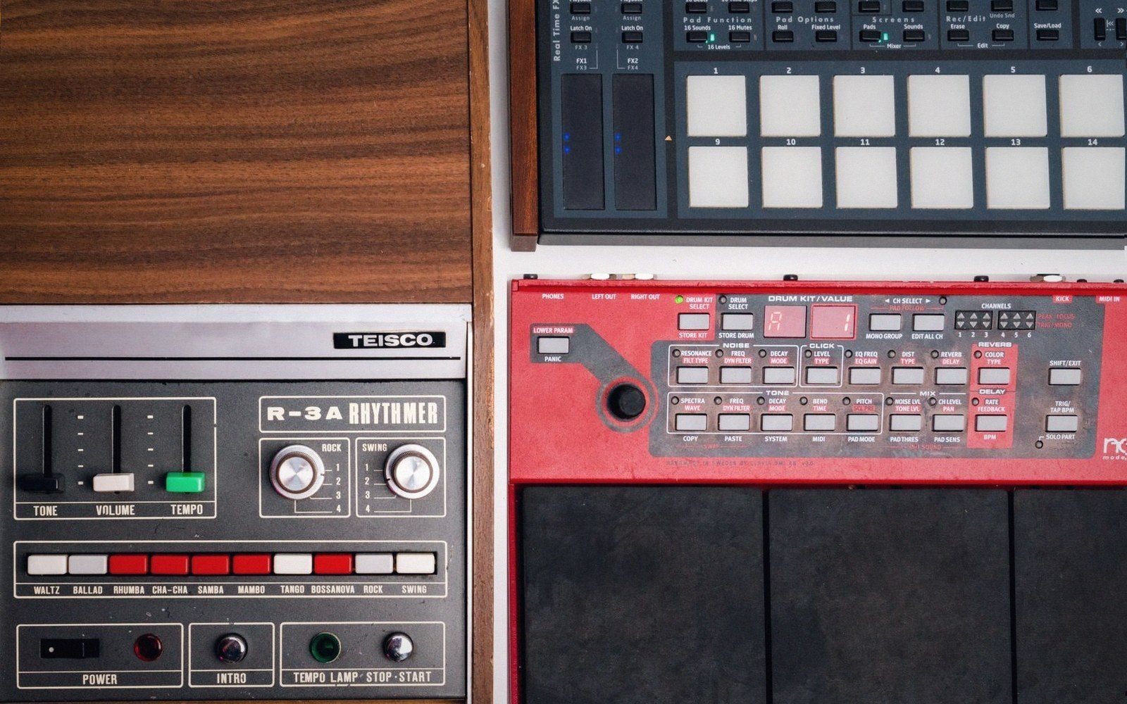A vintage Teisco R-3A Rhythmer drum machine beside a modern MPC-style sampler with pads