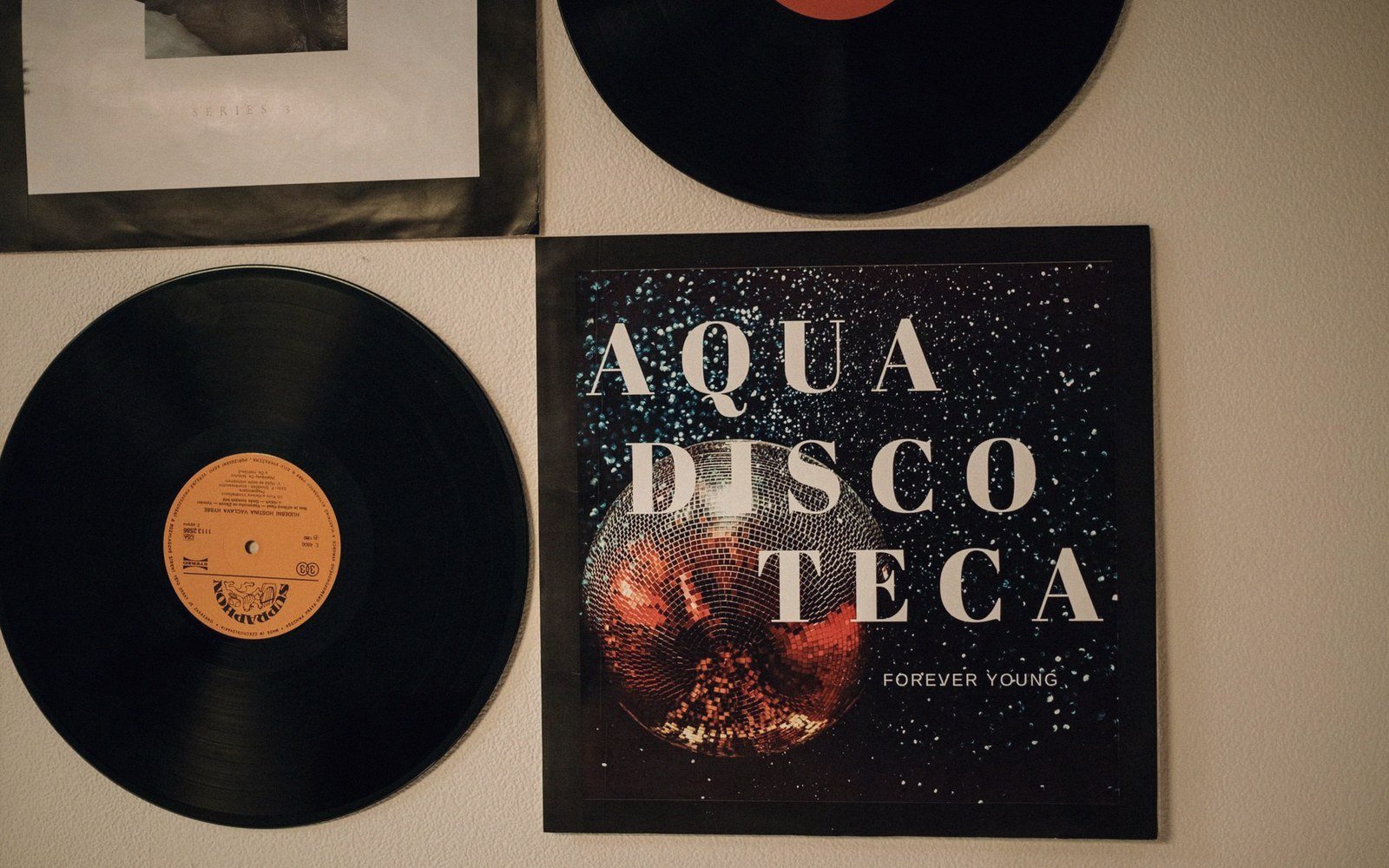A 12-inch record sleeve photographed face-on against a neutral ground, screen-printed in two colours on grey board